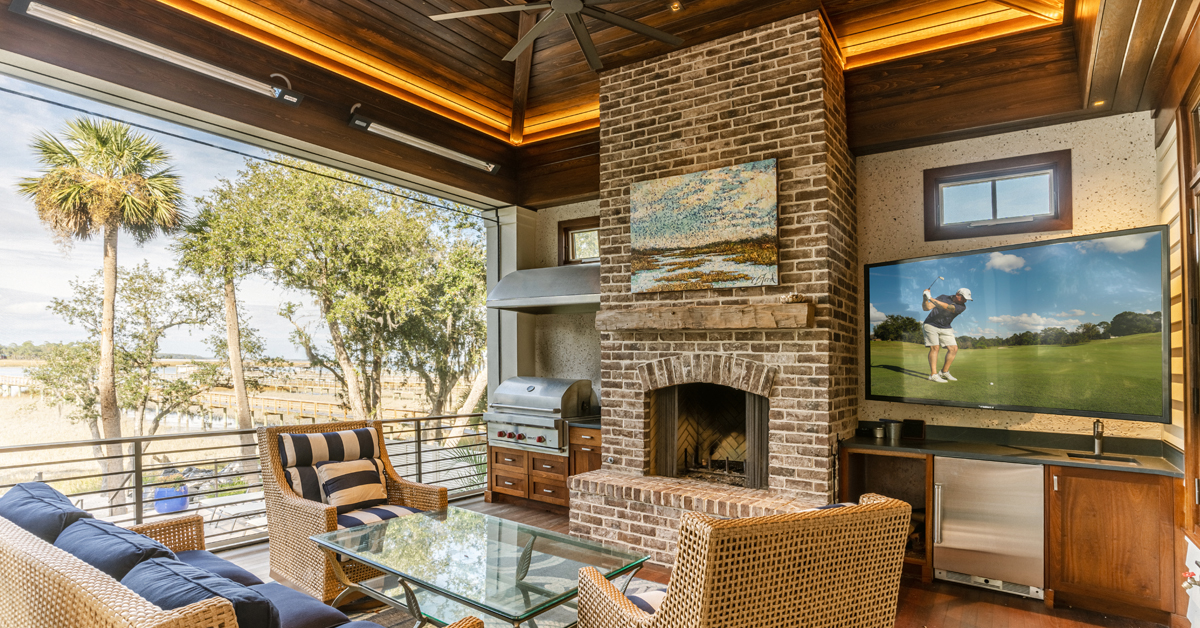 Outdoor living space with speakers, television, smart home controlled lighting and bug screens.